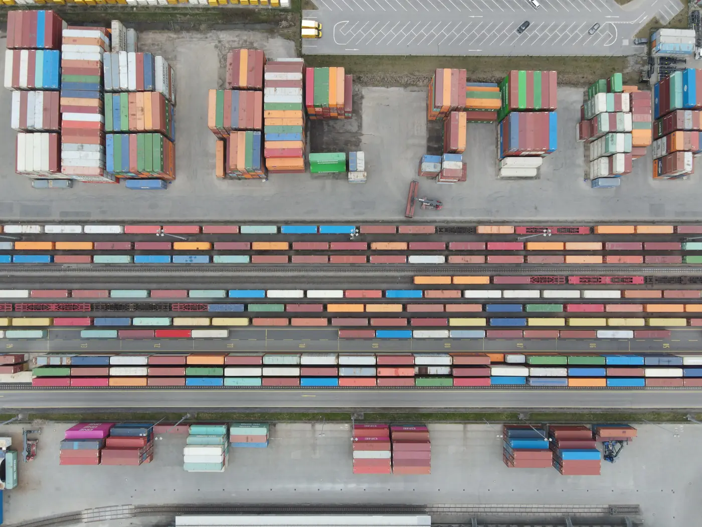 Aerial view of stacked shipping containers and rail lines representing the programmatic ad tech supply chain