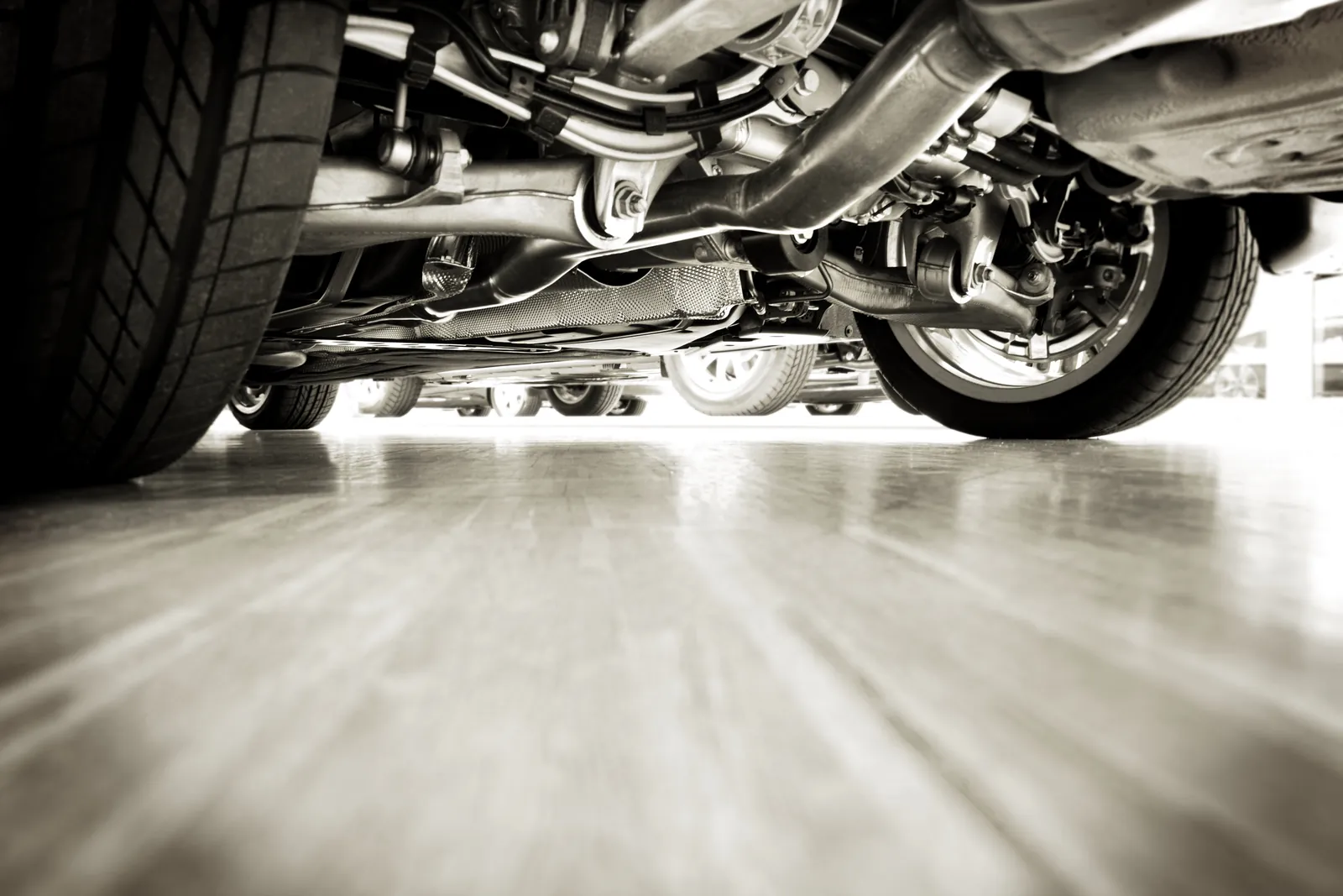 The underside of a car in a showroom row, representing the machinery beneath automotive media plans