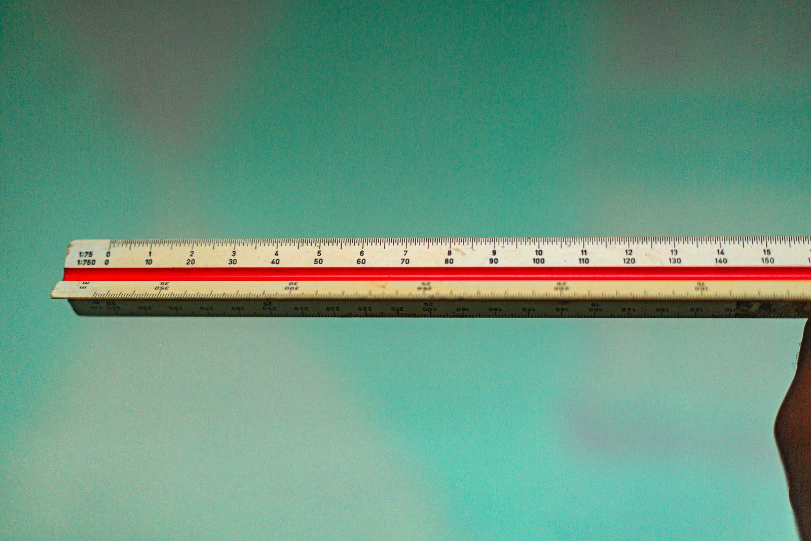 A triangular architect scale ruler against the sky, the wrong instrument for CTR benchmarks