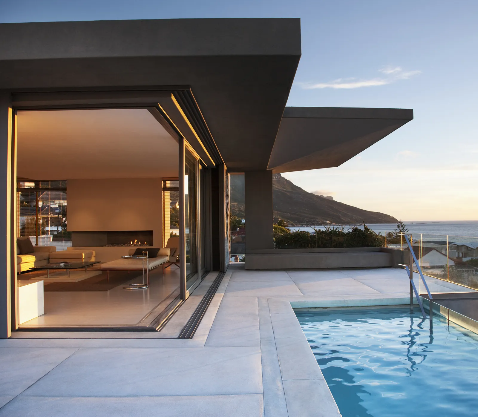 A modern home with a pool at dusk, representing demand generation for TF Cornerstone's residential portfolio