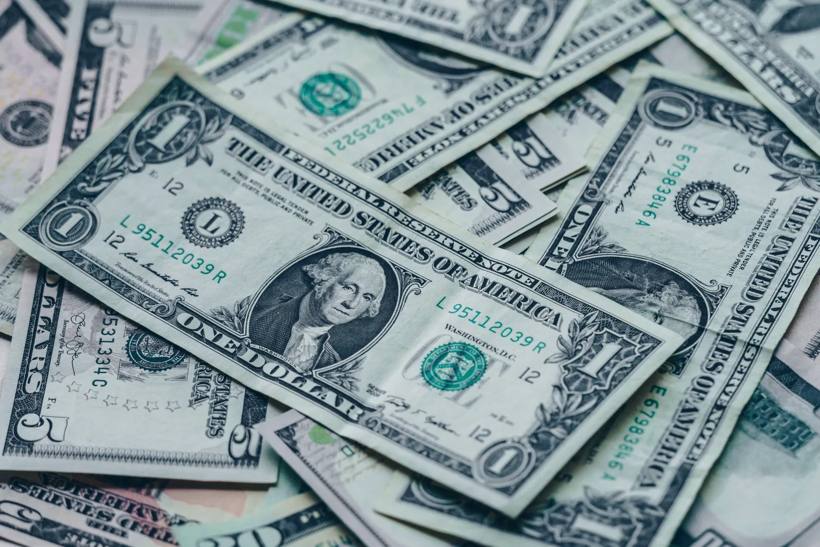 A spread of US dollar bills, representing the toll economics of retail and commerce media