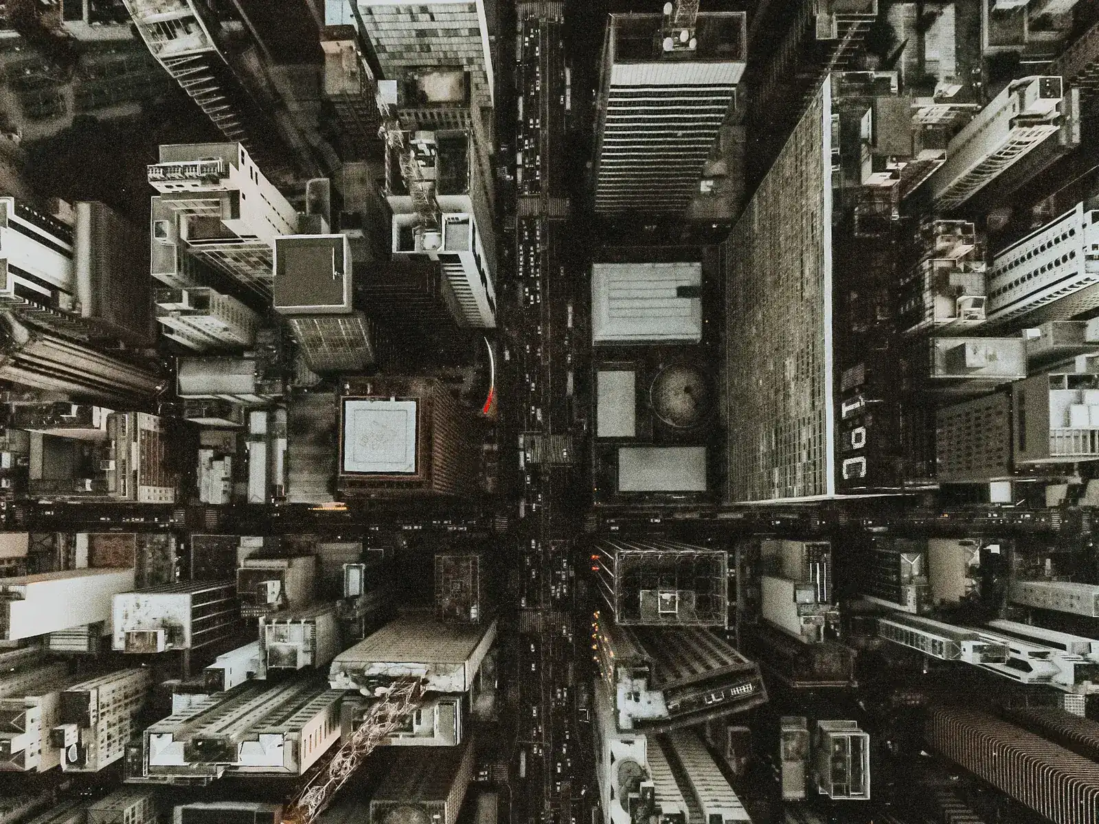 An aerial view straight down into dense city towers, representing real estate lease-up marketing