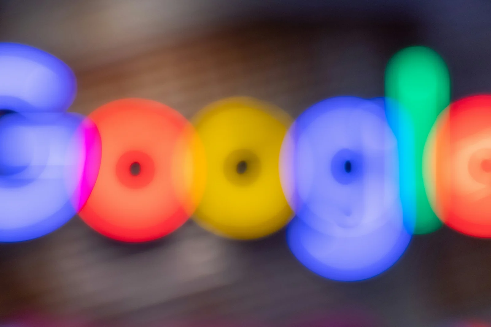 The Google sign photographed out of focus, where Google Ads costs begin