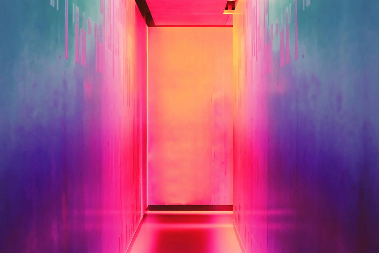 A corridor washed in neon gradients from teal to magenta to orange