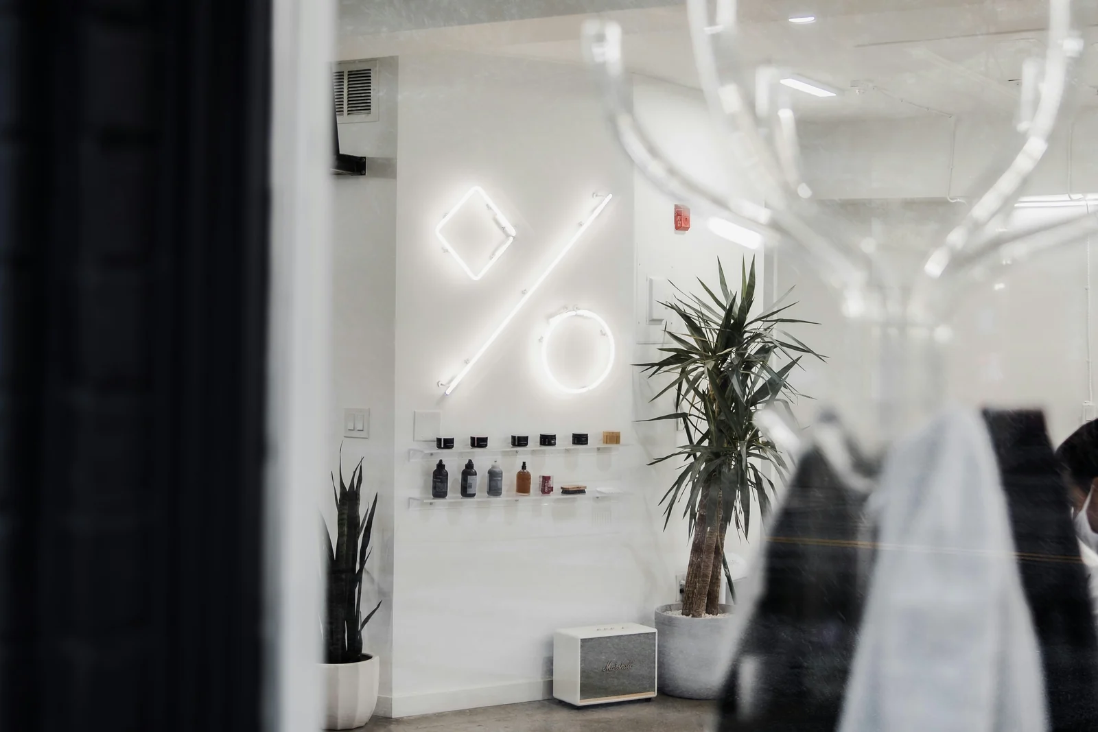 A white neon percent sign, impression share rendered literally