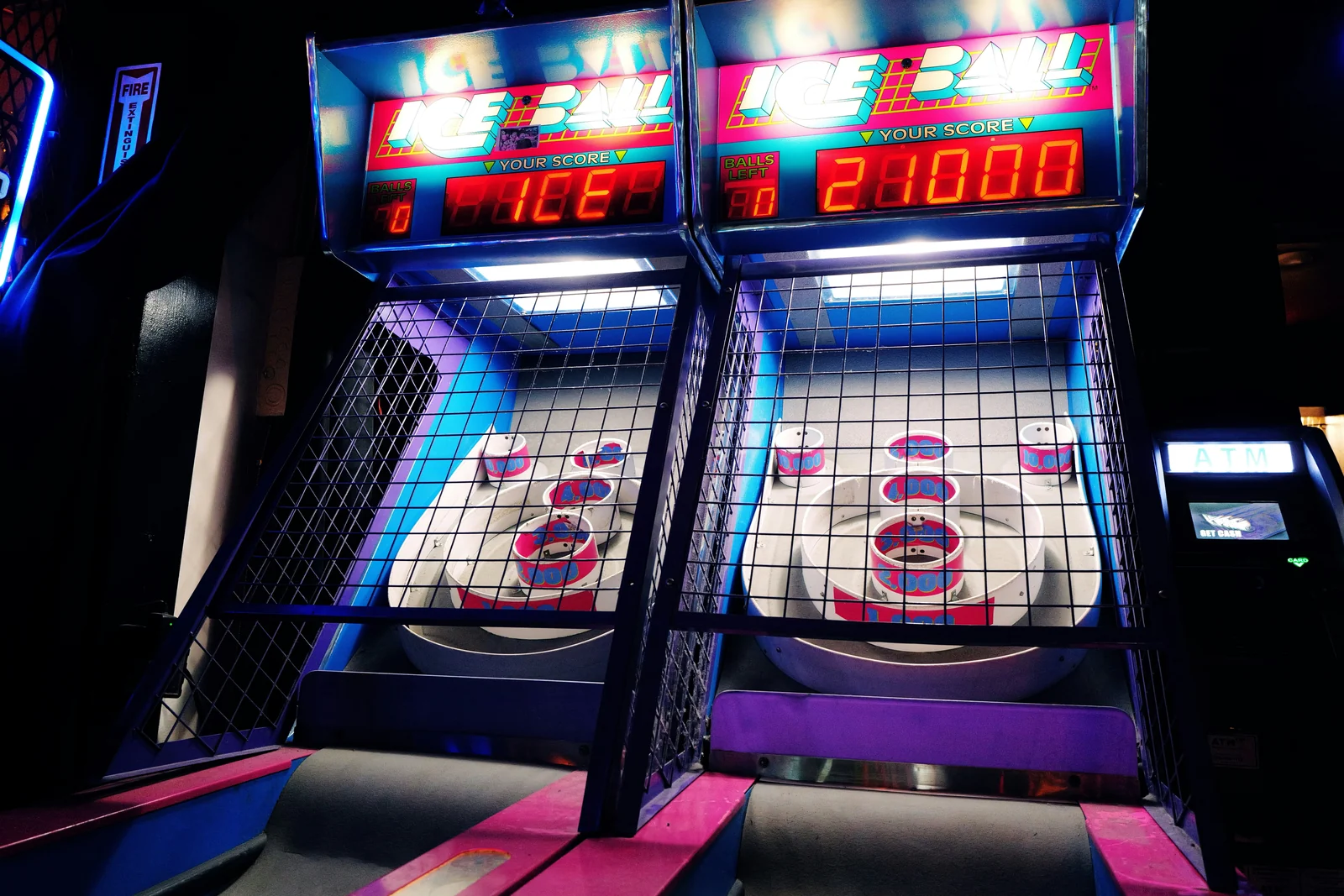 Arcade machines with glowing score displays, chasing Quality Score like a game