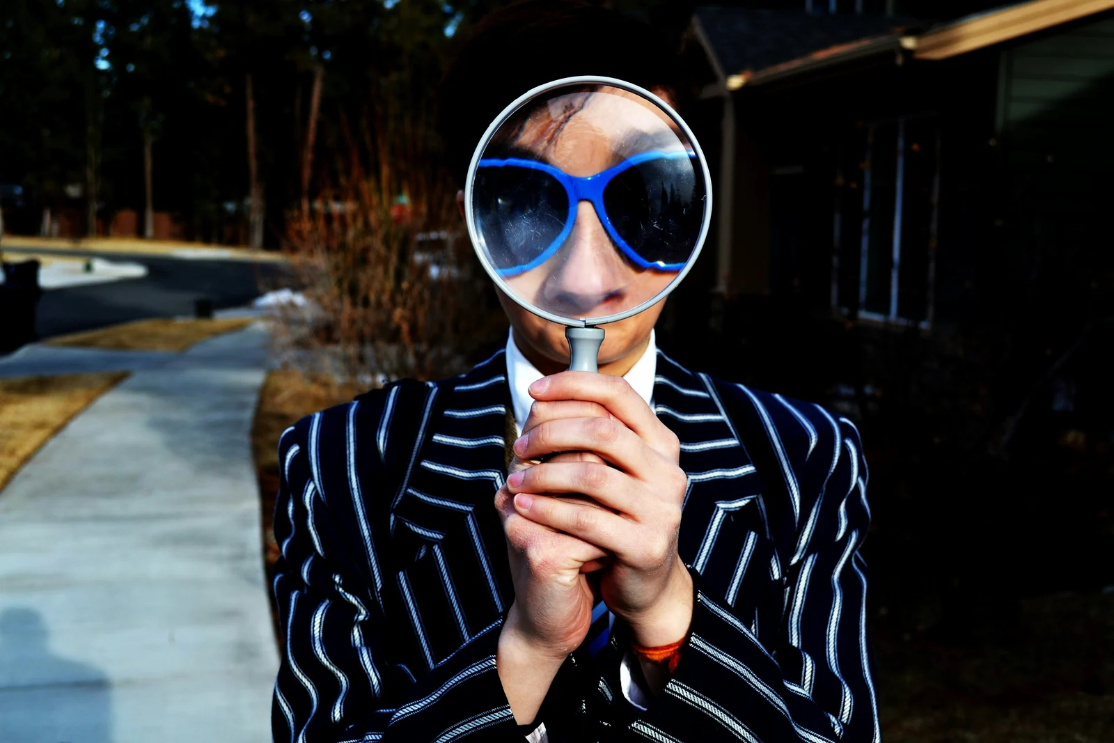 A person examining through a magnifying glass, weighing SEO against PPC