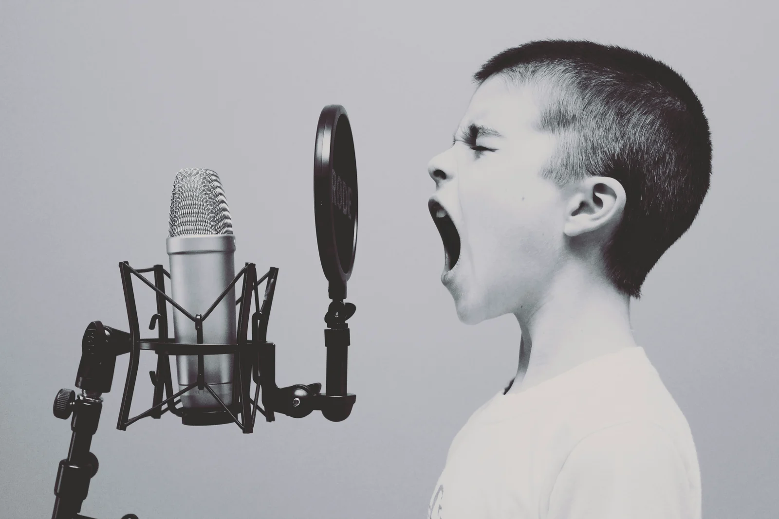A boy shouting into a studio microphone, share of voice made audible