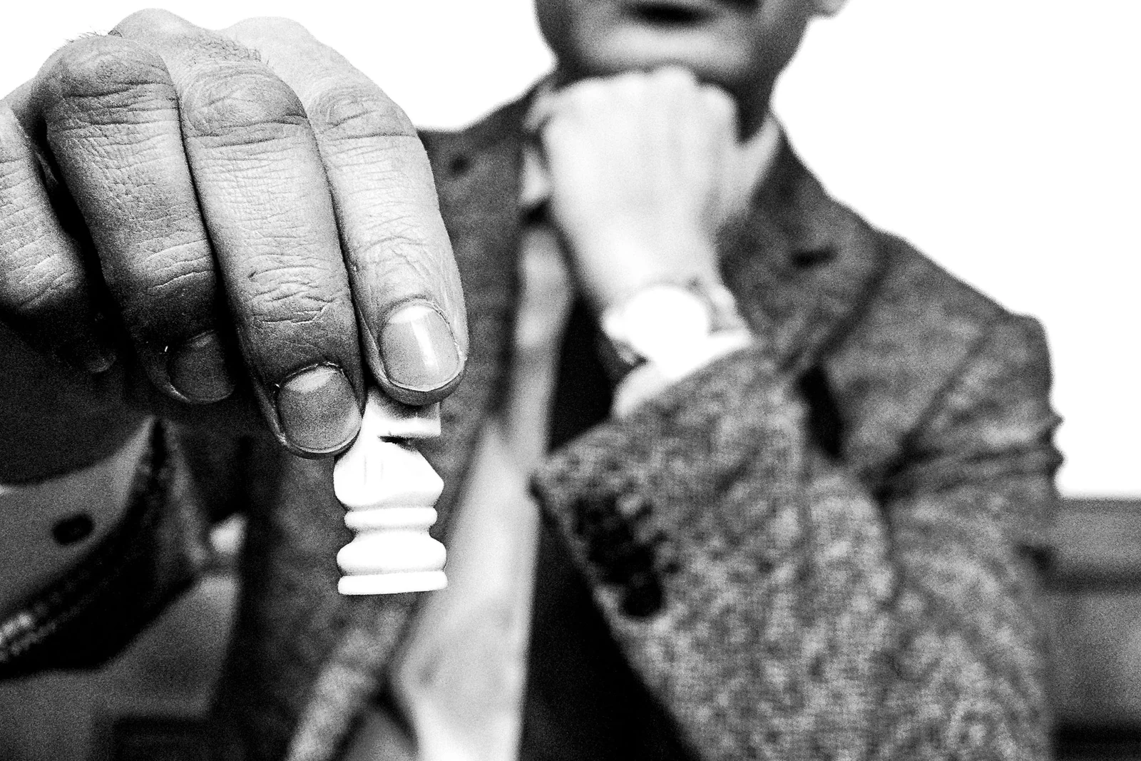 Black chess king standing while other pieces lie fallen, representing strategy versus tactics