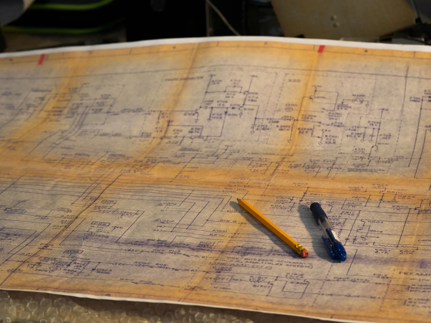 Vintage circuit wiring schematic with a pencil and pen, representing campaign tracking infrastructure
