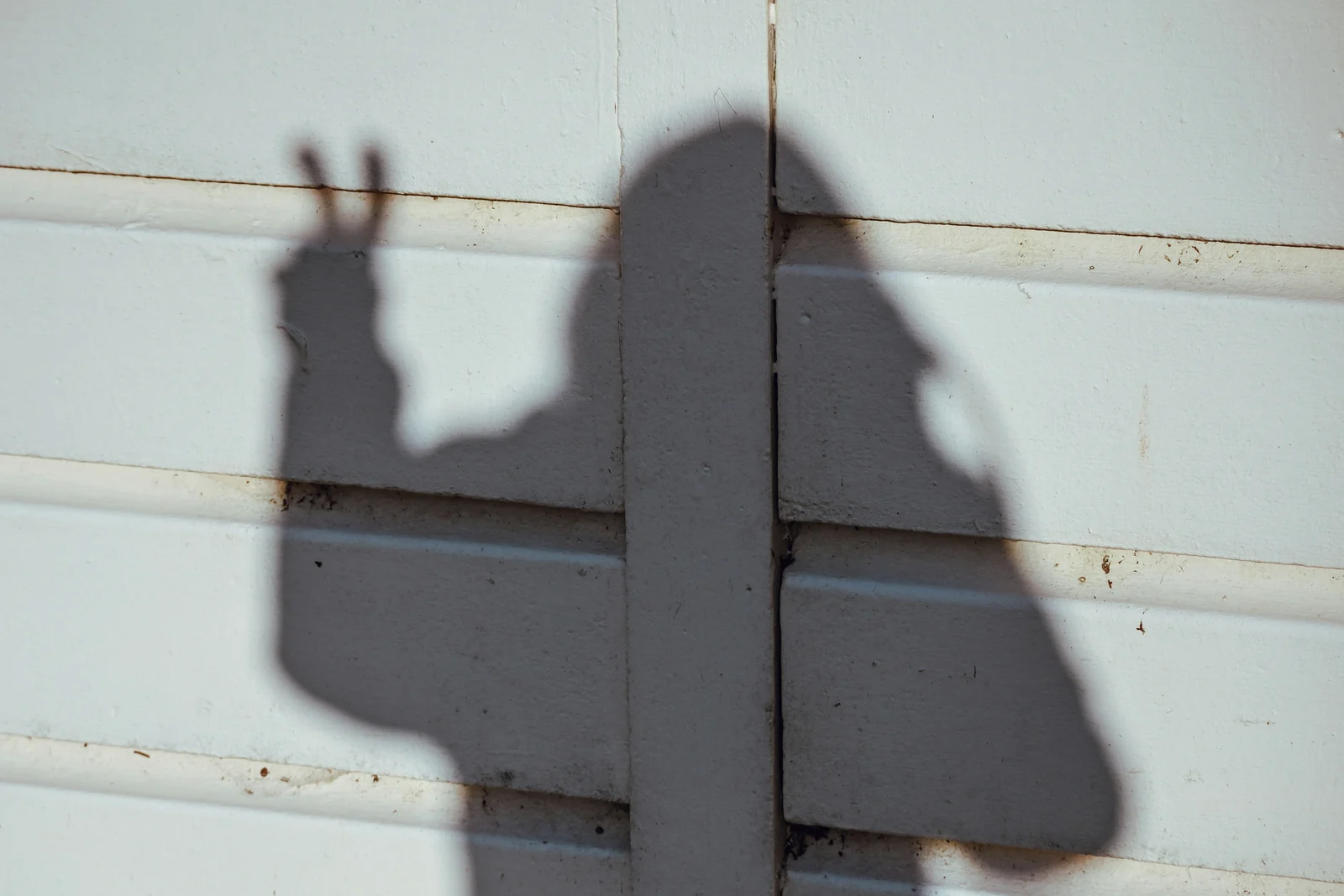 The shadow of a person filming themselves on a phone, UGC ads in silhouette
