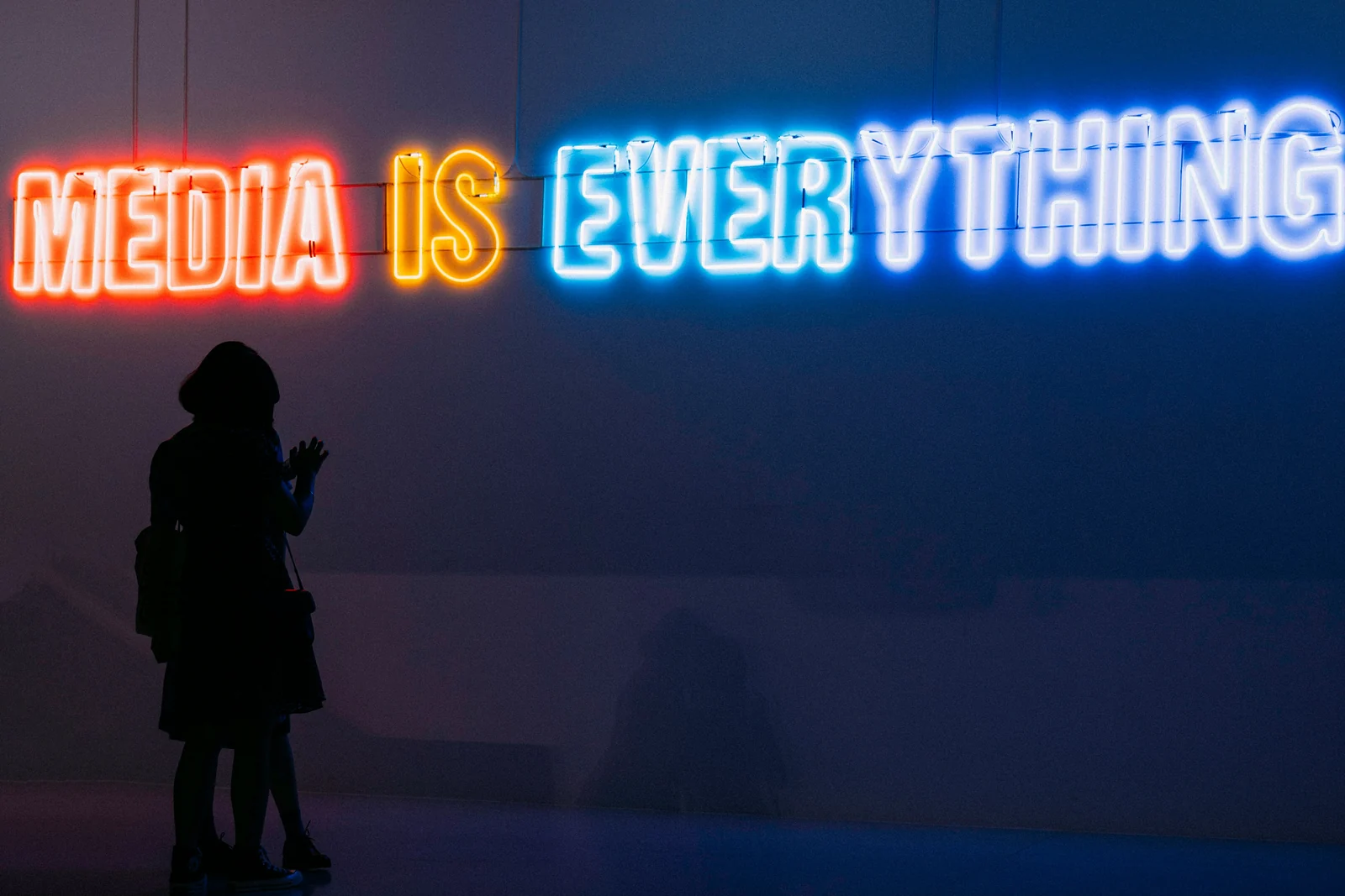 A neon sign reading media is everything, the premise marketing mix modeling tests