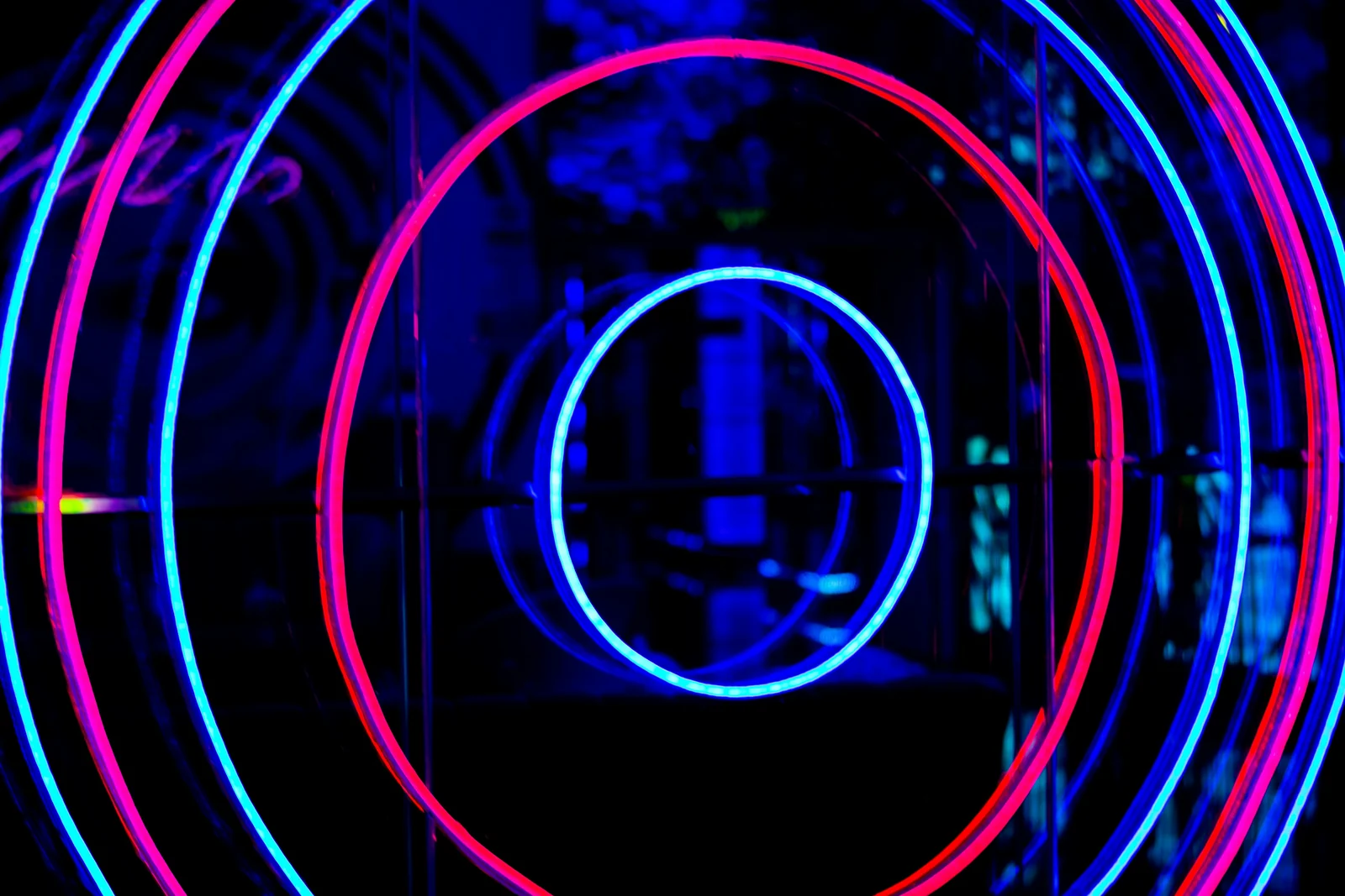 Concentric neon rings in red and blue like a target