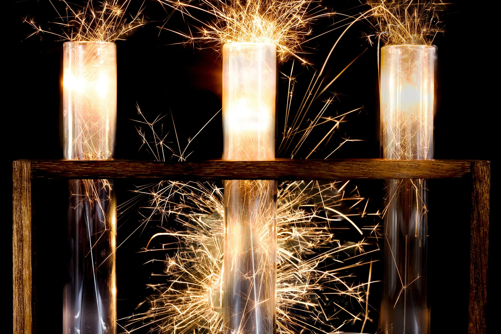 Sparklers burning in glass test tubes, an ad test still running