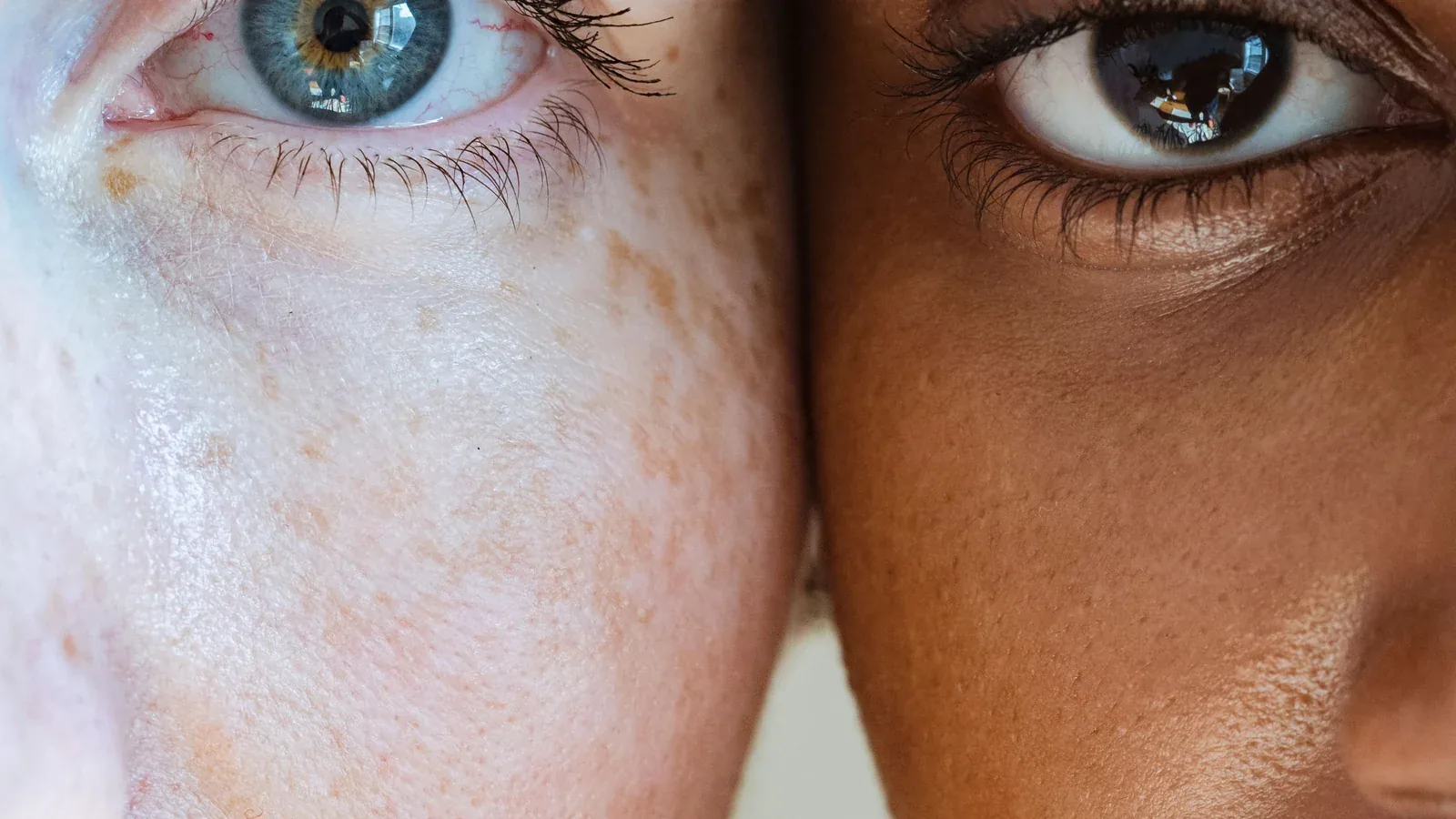 Close-up of two faces side by side, one fair and one dark-skinned: digital marketing and advertising for beauty and skincare brands