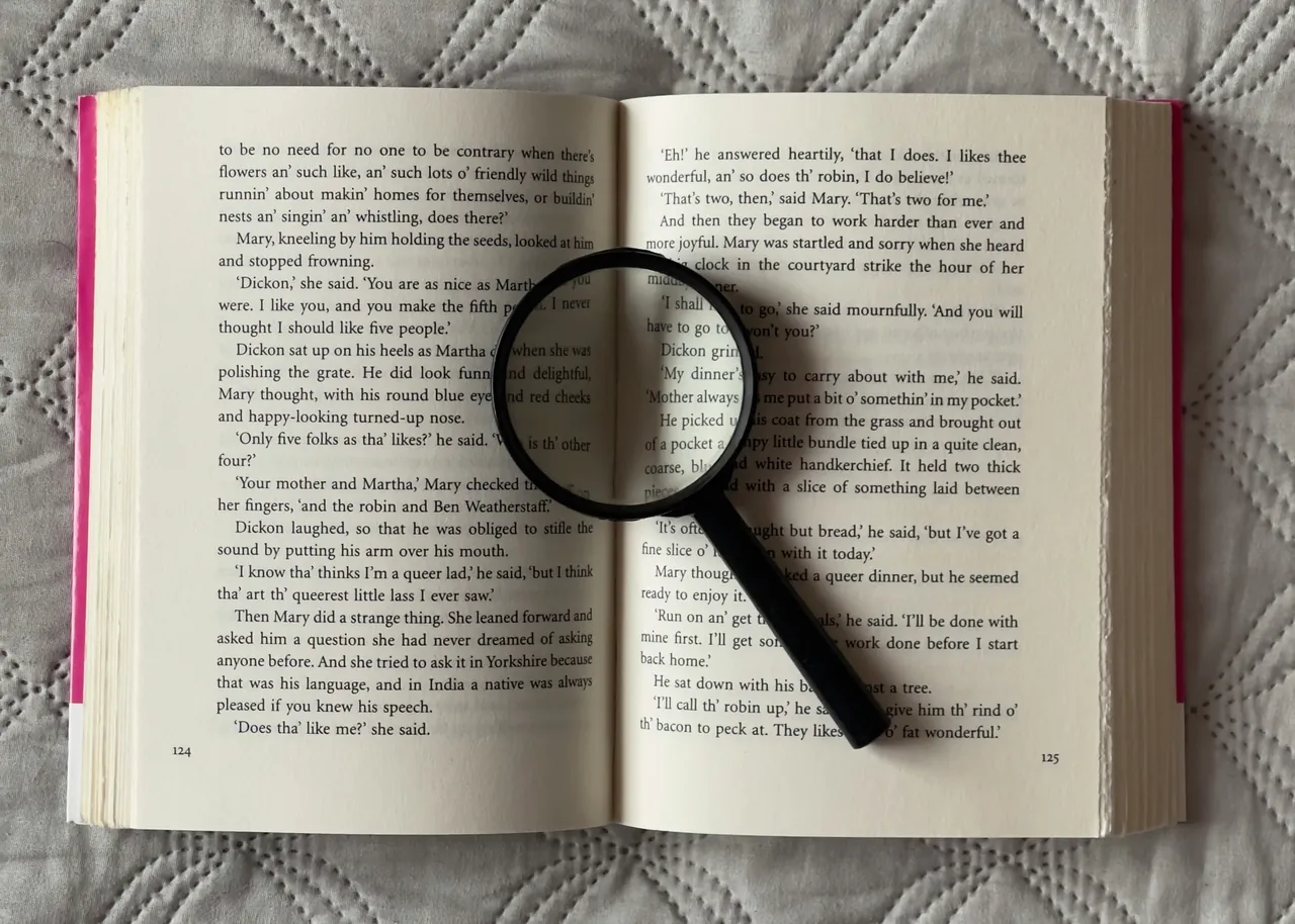 A magnifying glass resting on an open book: SEO and Generative Engine Optimization for visibility in AI answers from ChatGPT, Gemini, and Claude